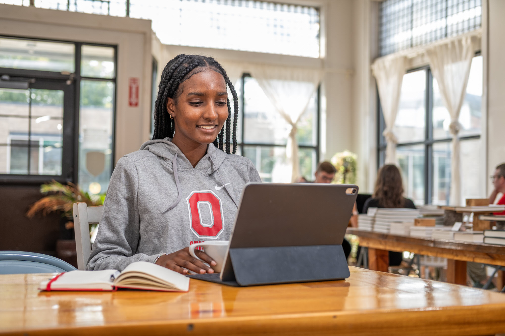 Student wearing a shirt with the Ohio State Block O using a tablet