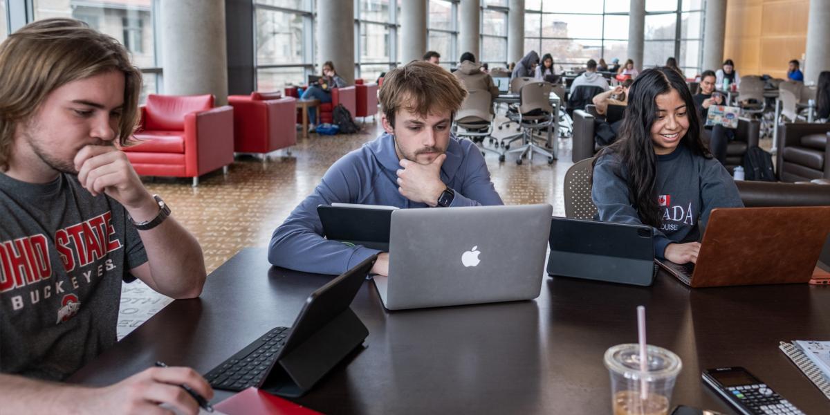Students using technology in a library